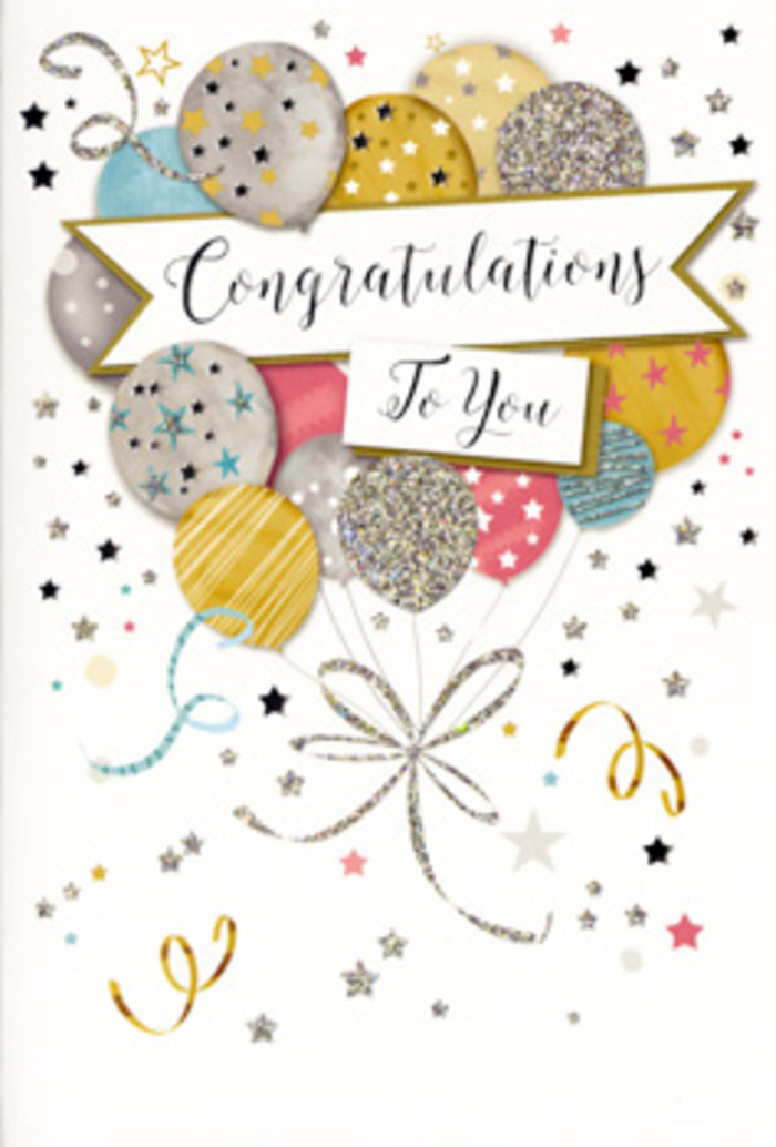 This photograph captures a beautifully designed congratulations card that feels instantly festive, as though it were created to sit proudly beside a celebratory bouquet from Lee Florist on a dining table near Hither Green or Burnt Ash Road. Dominating the front is a generous arrangement of illustrated balloons, gathered into a loose, organic bouquet that fills most of the vertical space. The balloons are perfectly round and subtly glossy, coloured in a sophisticated mix of champagne gold, brushed silver, muted blush pink, powder blue, and gentle grey. Each one is decorated with delicate details-tiny starbursts, fine stripes, or scattered, glitter-like dots-giving the impression of different textures and patterns, like carefully chosen party balloons. From their bases fall slender, curling ribbons, drawn in metallic shades of gold and silver, that swoop and loop in fluid curves, adding liveliness to the otherwise still illustration. Cutting horizontally across the centre of this bouquet is a white ribbon-shaped banner, softly curved and slightly raised in appearance, bearing the message "Congratulations To You" rendered in flowing, decorative script. The background of the card is pale and uncluttered, sprinkled with small metallic stars, dots, and swirling streamers that appear to dance around the main focal point, reminiscent of confetti drifting through the air after a toast at a local celebration in Lee. The printing suggests a combination of smooth card stock with selective glossy and glittery accents, so that, in person, parts of the design would catch and reflect light. Altogether, the card radiates warmth, achievement, and joy, making it an ideal partner to fresh flowers when marking exam results, a hard-earned promotion, or any momentous success that deserves to be remembered.